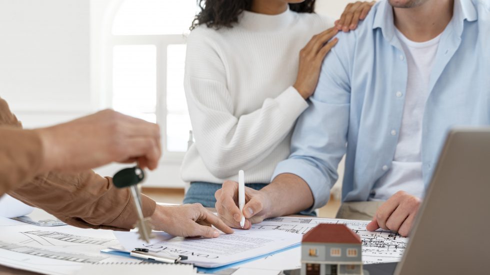 smiley-couple-signing-contract-new-house